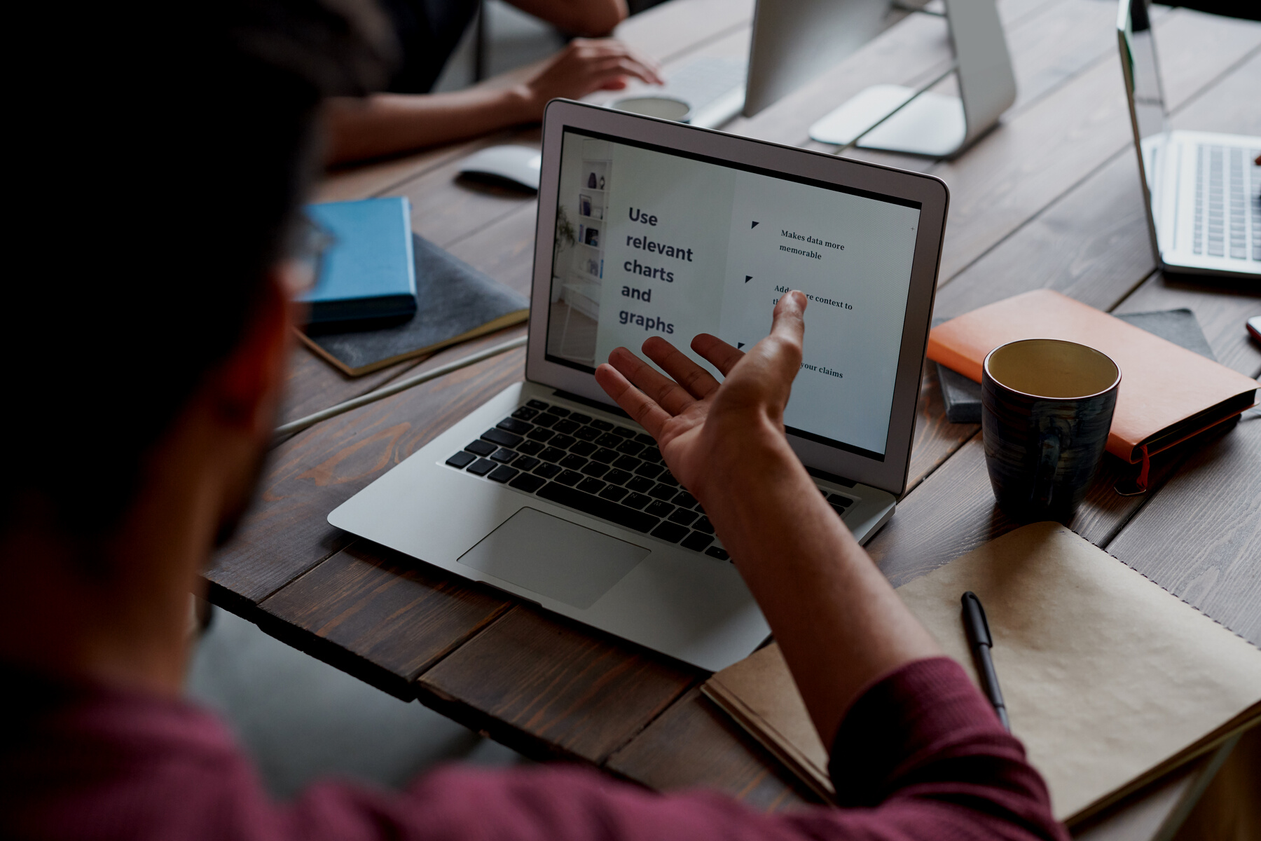 Person Sharing Ideas on Laptop